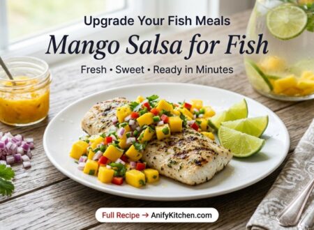 fresh mango salsa served over grilled fish with lime and herbs on wooden table